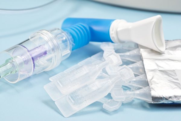 Sterile albuterol sulfate vials with nebulizer and mouthpiece. Albuterol is a common medication name.